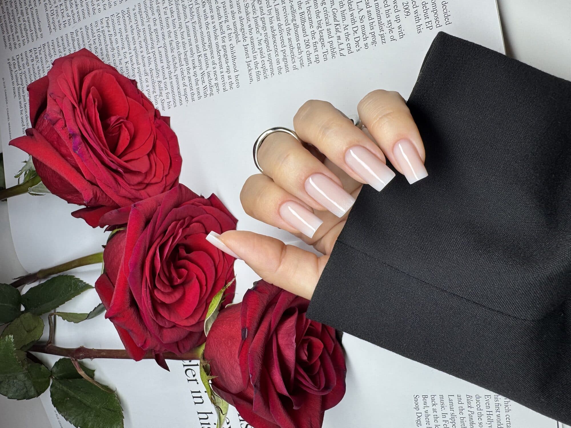 Nude glossy square nails styled with red roses