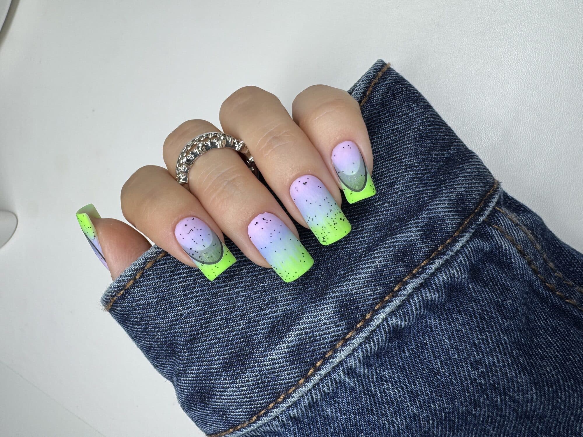 Lilac nails with neon green French tips