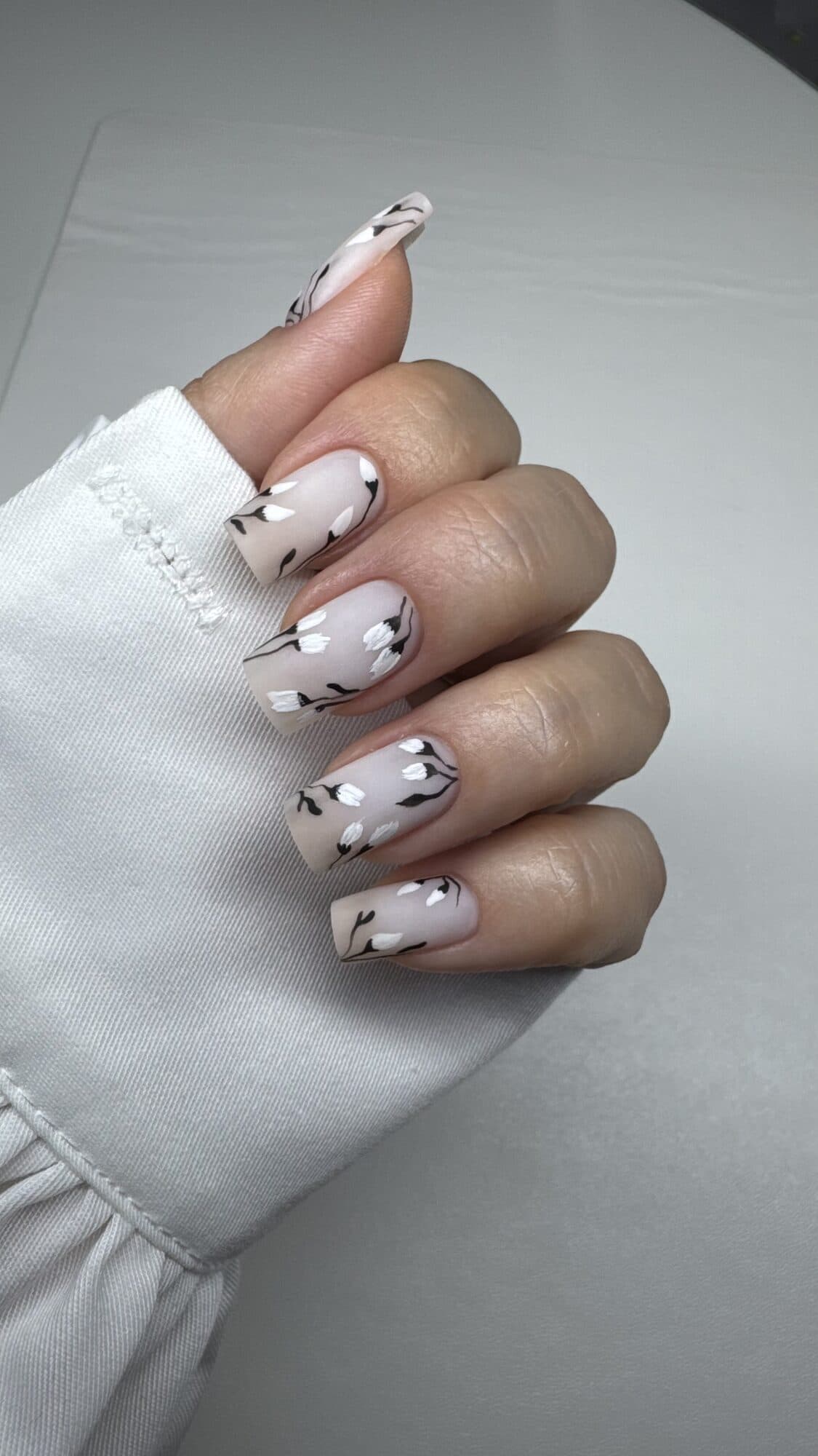 White square nails with fine black line art