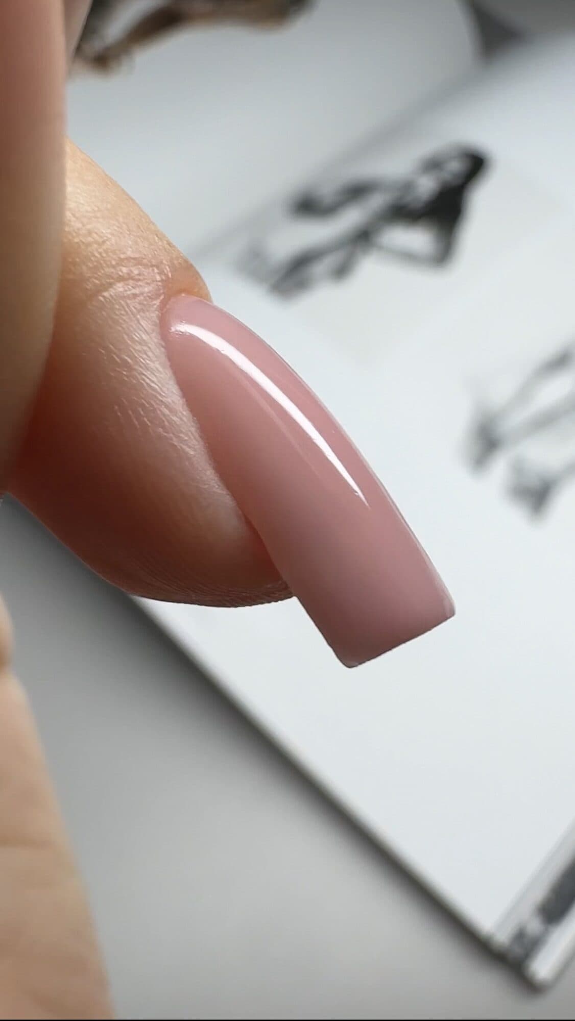 Close-up of a nude coffin nail extension